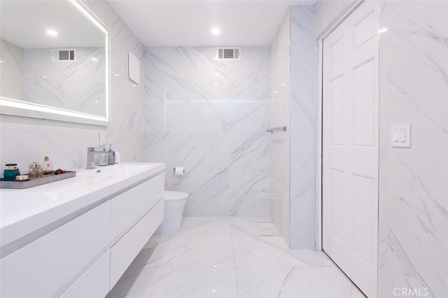 16040 W Sunset Blvd Unit 102, Pacific Palisades, CA 90272 - full bathroom featuring marble finish floor, tile walls, visible vents, and toilet