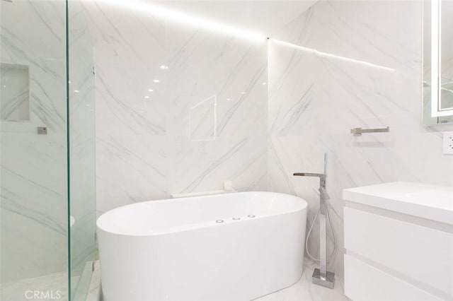 16040 W Sunset Blvd Unit 102, Pacific Palisades, CA 90272 - full bathroom with a soaking tub, tile walls, vanity, and a marble finish shower