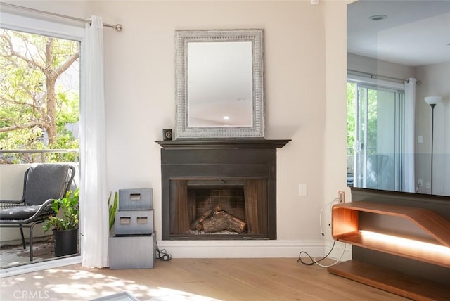 16040 W Sunset Blvd Unit 102, Pacific Palisades, CA 90272 - sitting room with a fireplace and wood finished floors
