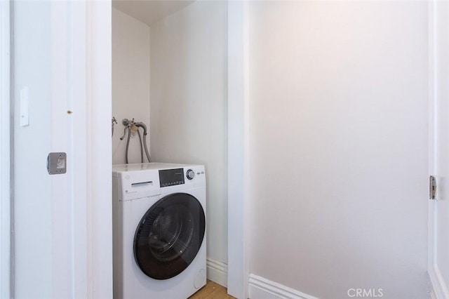 16040 W Sunset Blvd Unit 102, Pacific Palisades, CA 90272 - laundry area featuring baseboards, washer / clothes dryer, laundry area, and light wood-type flooring