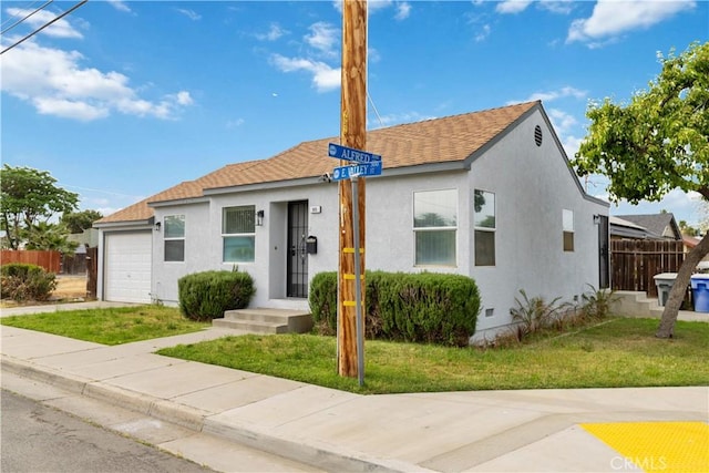385 E Valley St, Coalinga, CA 93210 - view of front of property featuring a garage, stucco siding, a front lawn, and fence