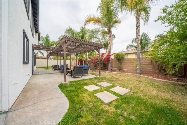 view of yard with a pergola, a fenced backyard, and a patio