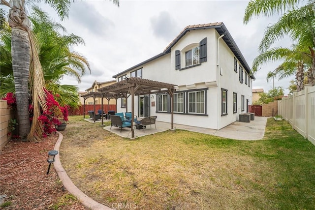 rear view of house with a pergola, a fenced backyard, a patio, and stucco siding