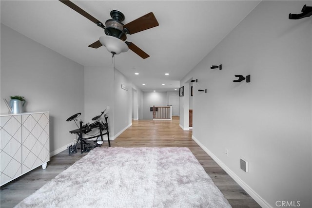 interior space with recessed lighting, wood finished floors, and baseboards