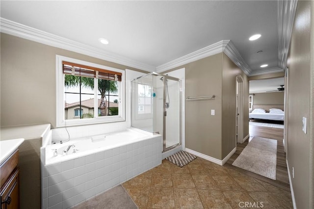 ensuite bathroom with a bath, baseboards, a shower stall, vanity, and ornamental molding
