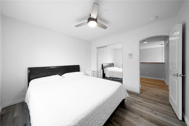 1639 Tivoli St, Redlands, CA 92374 - bedroom with arched walkways, baseboards, a closet, and wood finished floors