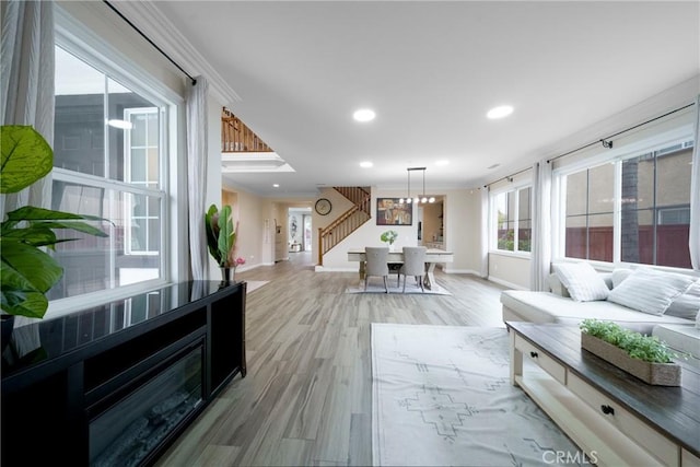 interior space featuring recessed lighting, light wood-style floors, crown molding, and baseboards