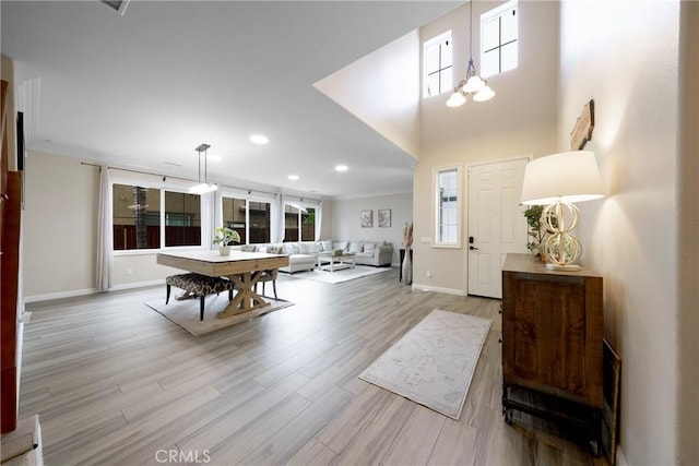 foyer featuring baseboards, wood finished floors, and recessed lighting