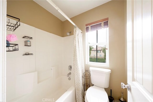 bathroom featuring toilet and shower / bath combo with shower curtain