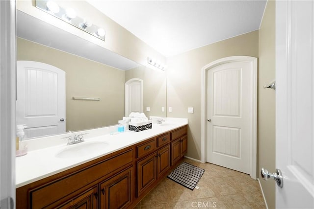 full bath with tile patterned floors, a sink, and double vanity