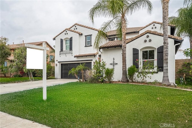 mediterranean / spanish house with a tile roof, a garage, concrete driveway, a front yard, and stucco siding