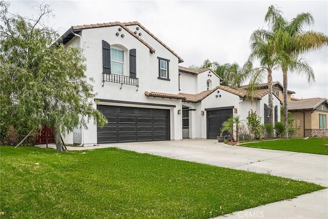 mediterranean / spanish-style house featuring a tile roof, concrete driveway, a front lawn, and stucco siding