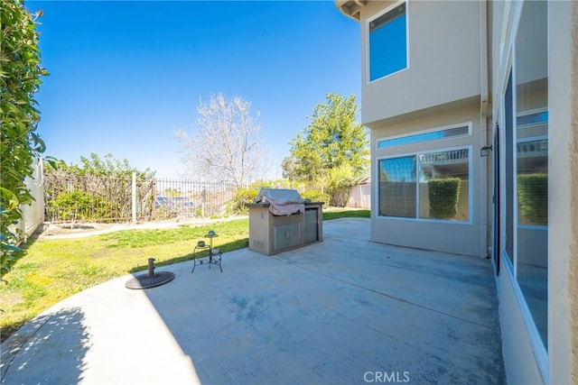 view of patio featuring grilling area and fence