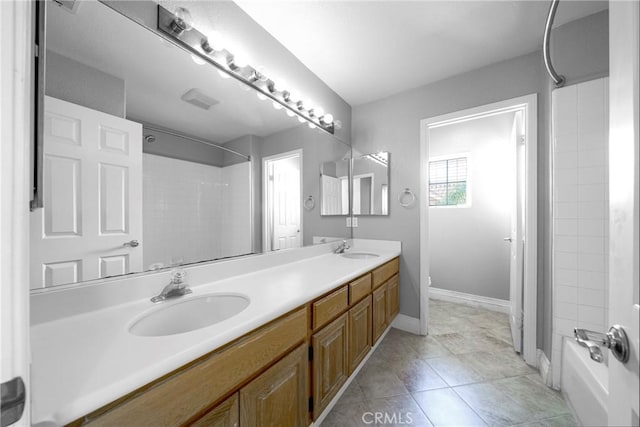 full bathroom featuring double vanity, shower / bathtub combination with curtain, baseboards, and a sink
