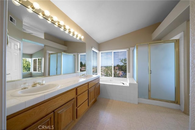 bathroom featuring visible vents, lofted ceiling, a sink, a shower stall, and a garden tub