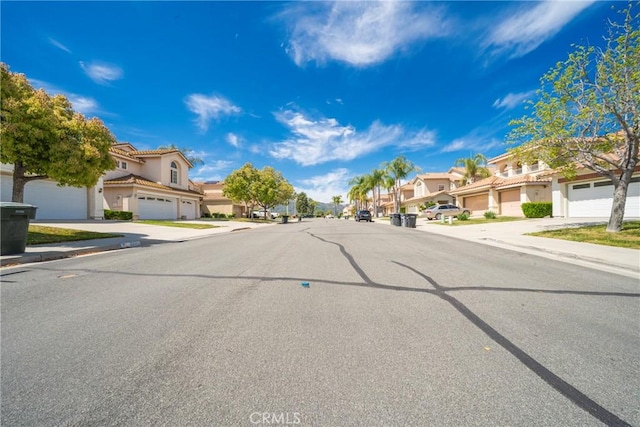 view of street with curbs, a residential view, and sidewalks
