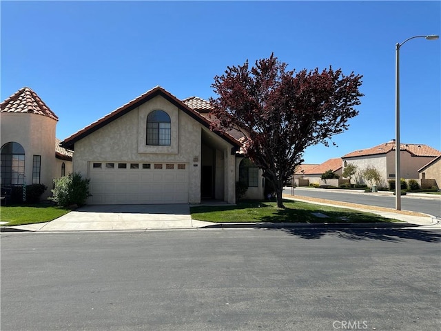 19229 Pine Way, Apple Valley, CA 92308 - mediterranean / spanish-style home featuring stucco siding, a tiled roof, concrete driveway, and a garage