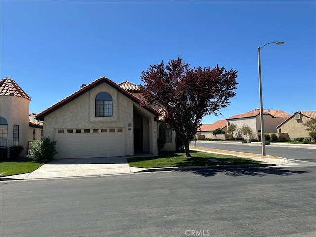 19229 Pine Way, Apple Valley, CA 92308 - mediterranean / spanish home with stucco siding, a tile roof, driveway, and a garage
