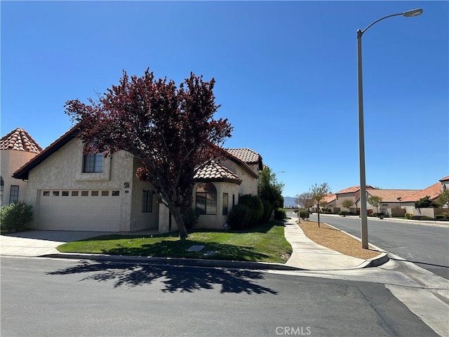 19229 Pine Way, Apple Valley, CA 92308 - view of front facade featuring a tile roof, stucco siding, a garage, and a front lawn