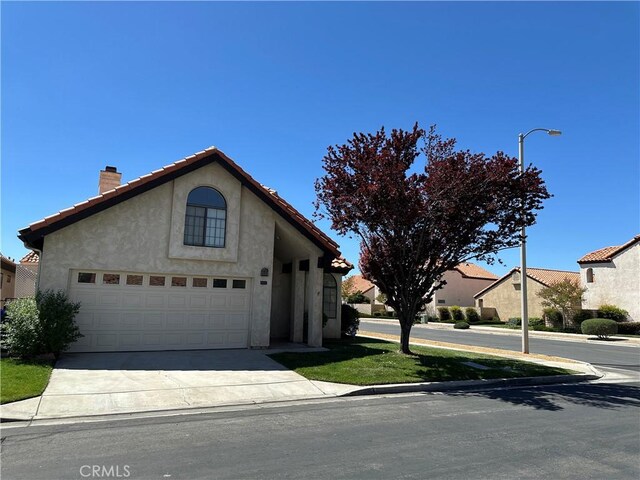 19229 Pine Way, Apple Valley, CA 92308 - view of front of home featuring a chimney, stucco siding, concrete driveway, a garage, and a tile roof