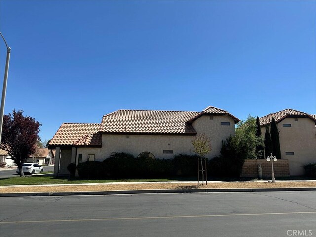 19229 Pine Way, Apple Valley, CA 92308 - view of side of property featuring a tile roof and stucco siding