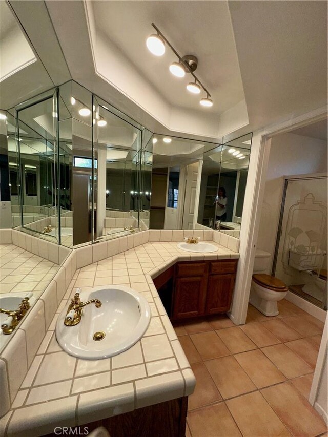 19229 Pine Way, Apple Valley, CA 92308 - full bath with double vanity, a tray ceiling, tile patterned floors, and toilet