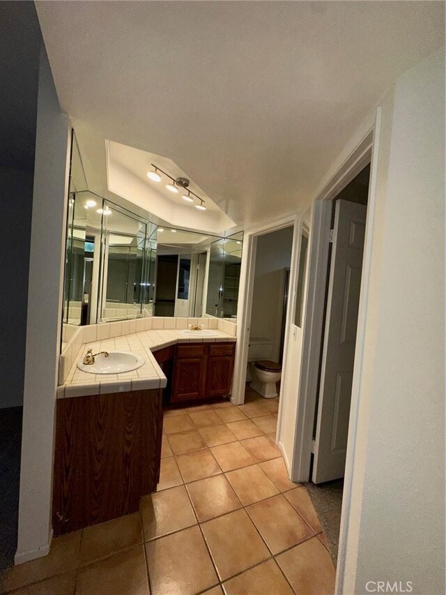19229 Pine Way, Apple Valley, CA 92308 - bathroom featuring vanity, tile patterned flooring, toilet, and a raised ceiling