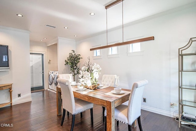 dining space featuring visible vents, washer and clothes dryer, baseboards, and dark wood finished floors