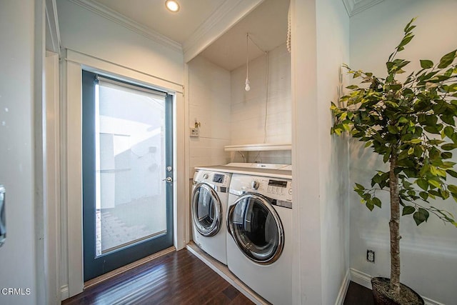 washroom with laundry area, dark wood-style flooring, ornamental molding, and washer and clothes dryer
