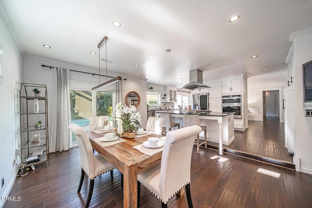 dining space with recessed lighting, dark wood-style flooring, baseboards, and crown molding