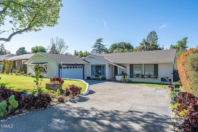ranch-style house featuring driveway, board and batten siding, an attached garage, and a front lawn
