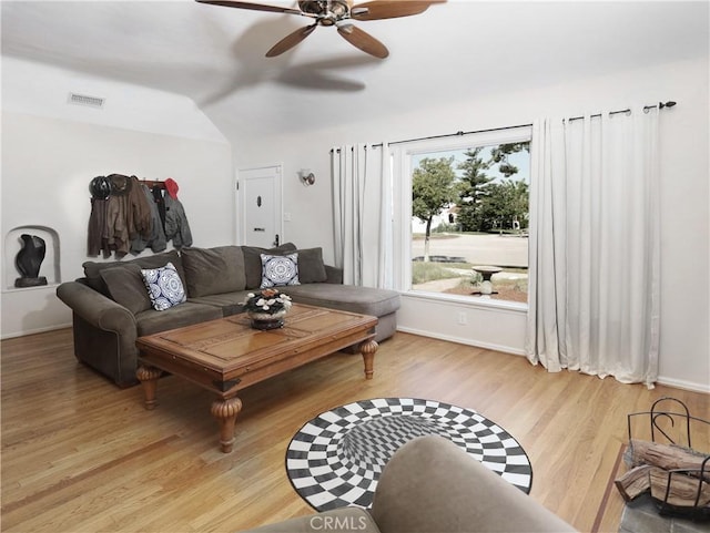 living room featuring visible vents, ceiling fan, baseboards, and light wood-style flooring