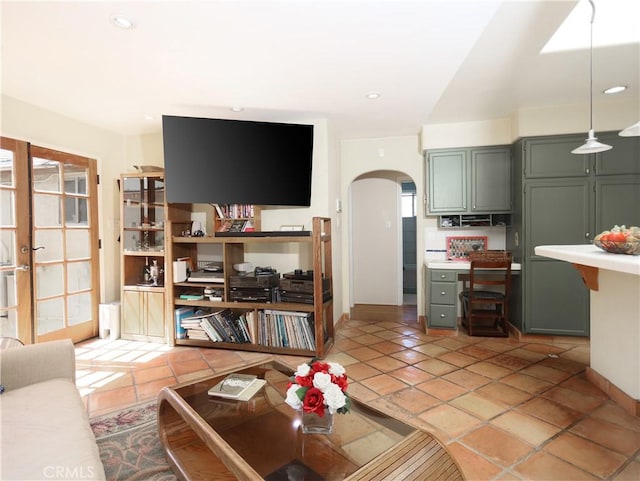 living room with recessed lighting and arched walkways