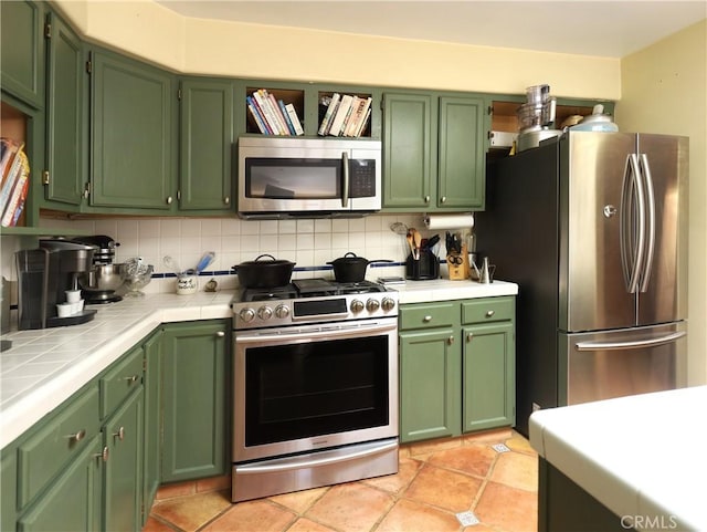 kitchen with tile counters, backsplash, and appliances with stainless steel finishes