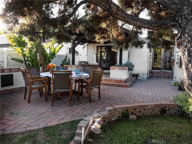 view of patio / terrace featuring entry steps, fence, and outdoor dining area