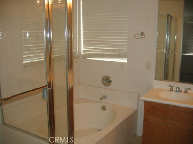 1590 River Wood Ct, Simi Valley, CA 93063 - full bathroom featuring a bath, a shower stall, and vanity