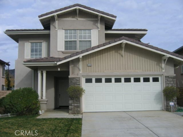 1590 River Wood Ct, Simi Valley, CA 93063 - view of front facade featuring driveway, stucco siding, and stone siding