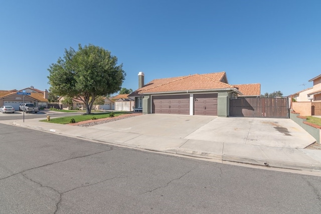 39203 Foxglove Cir, Murrieta, CA 92563 - ranch-style home with a tiled roof, fence, a gate, an attached garage, and driveway