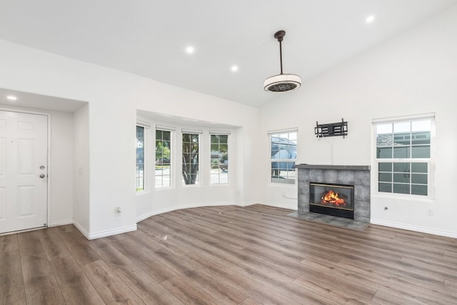 39203 Foxglove Cir, Murrieta, CA 92563 - unfurnished living room featuring a tiled fireplace, wood finished floors, and baseboards