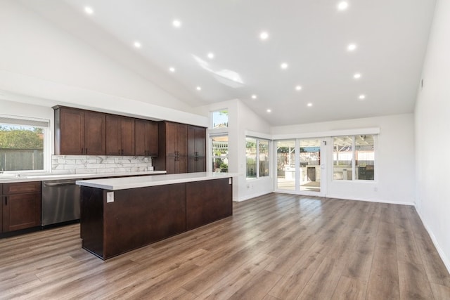 39203 Foxglove Cir, Murrieta, CA 92563 - kitchen with high vaulted ceiling, a center island, light countertops, backsplash, and stainless steel dishwasher