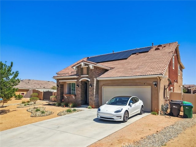 41908 Sonoma Rd, Palmdale, CA 93551 - mediterranean / spanish house featuring concrete driveway, roof mounted solar panels, an attached garage, a tiled roof, and stucco siding