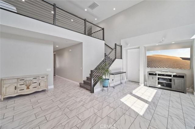 41908 Sonoma Rd, Palmdale, CA 93551 - unfurnished living room with stairway, a towering ceiling, and recessed lighting