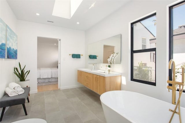 full bathroom with connected bathroom, a healthy amount of sunlight, visible vents, and a skylight