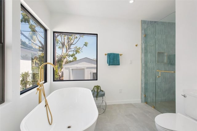 full bath with a tile shower, toilet, baseboards, recessed lighting, and a freestanding tub