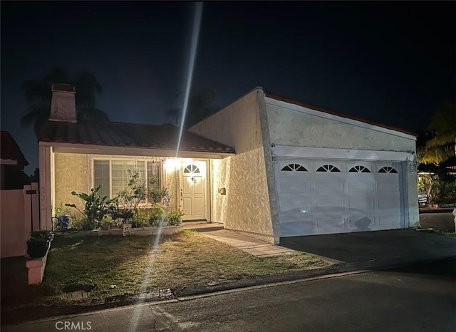 26671 Paseo Tecate, San Juan Capistrano, CA 92675 - view of front facade featuring a garage, stucco siding, and aphalt driveway