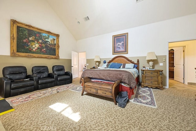 bedroom featuring high vaulted ceiling, carpet flooring, and visible vents