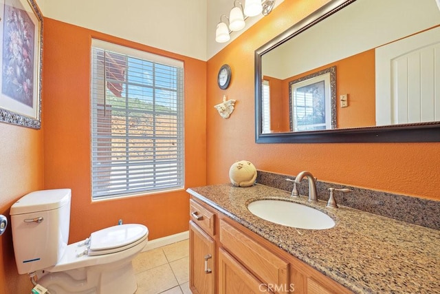 bathroom featuring toilet, tile patterned floors, vanity, and baseboards