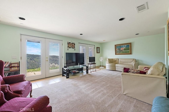 living area featuring french doors, light tile patterned flooring, visible vents, and recessed lighting