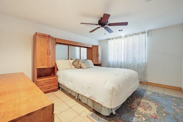 bedroom featuring ceiling fan, baseboards, and light tile patterned flooring