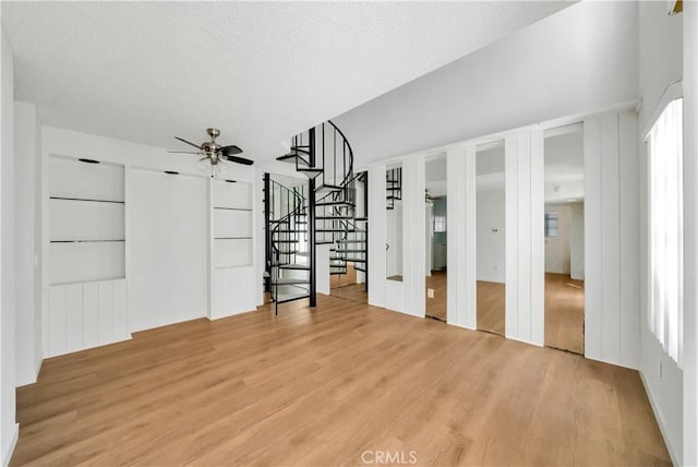 interior space with light wood finished floors and a textured ceiling